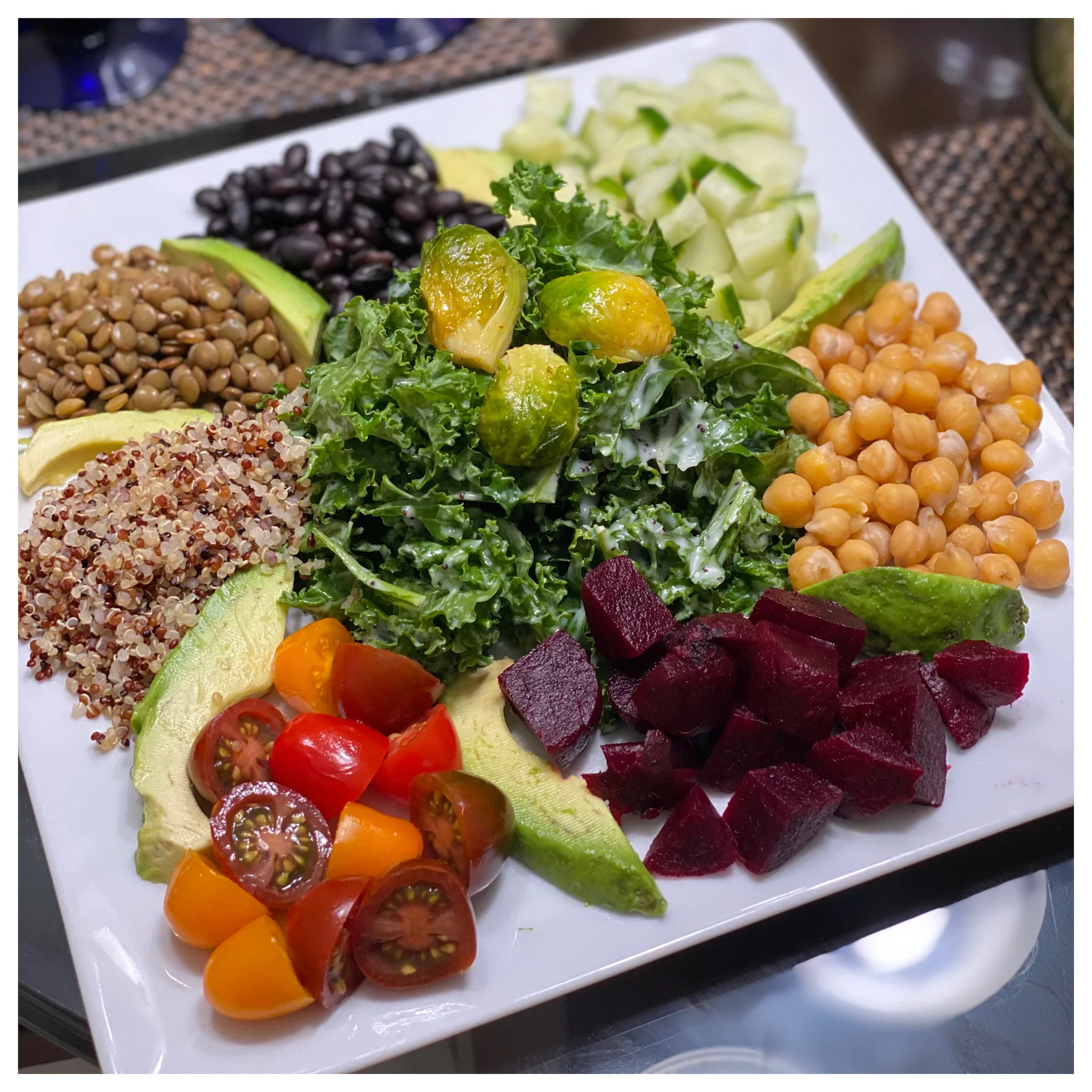 Colorful BEVeganly Fresh salad with greens, grains, beans, and vegetables
